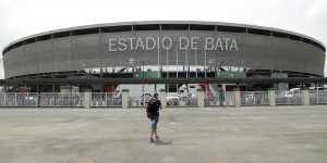 A man walks in front of the Bata stadium in Bata, Equatorial Guinea, Friday Jan. 16, 2015 which will host the opening African Cup of Nations Group A soccer match on Saturday between the tournament hosts and Congo. (AP Photo/Themba Hadebe)